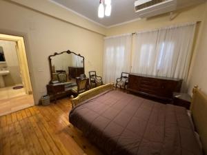 a bedroom with a large bed and a mirror at Prime location 2 bed rooms Apartment , near the Nile & Cairo Center in Cairo