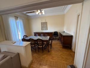 a living room with a dining room table and chairs at Prime location 2 bed rooms Apartment , near the Nile & Cairo Center in Cairo
