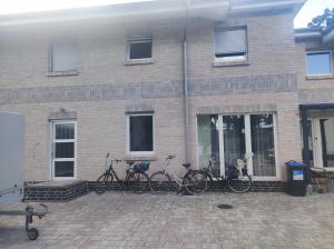 a group of bikes parked outside of a brick building at Zwei Buchen in BRE