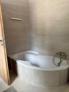 a white bath tub in a bathroom with a shower at Zwei Buchen in BRE +13 photos