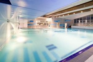 a large swimming pool in a building at Eden Resort & Spa in Mielno