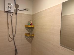 a bathroom with a shower with a shower head at Heart of Cebu Cozy Studio with Pool, Gym, Wifi and Netflix near Cebu City,Ayala and IT Park in Cebu City