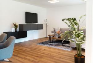 a living room with a tv on a wall at Frisch renoviert & gemütlich mit Terasse in Sulzbach