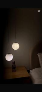 two lights on a table in a dark room at Studio in Al-Aqiq شقه رقم 15 و in Riyadh +1 photo