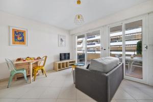 a living room with a couch and a table at PALACIO- Centre-Ville - Parking privé - Proche Mer - Grande terrasse in Menton