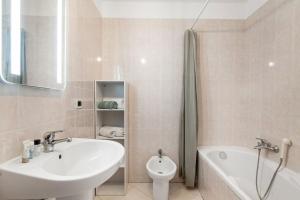 a bathroom with a sink and a tub and a toilet at PALACIO- Centre-Ville - Parking privé - Proche Mer - Grande terrasse in Menton +16 photos