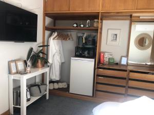 a room with a kitchen with a refrigerator and a shelf at Launceston Lovely Vegan Homestay in Launceston +48 photos