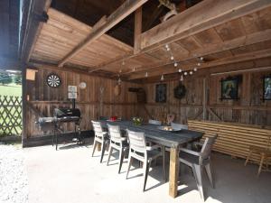 a wooden dining room with a table and chairs at Chalet in Levínská Ole near Giant Mountains in Levínská Olešnice
