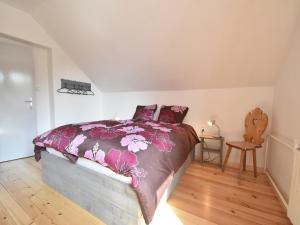 a bedroom with a bed with a floral bedspread at Chalet in Levínská Ole near Giant Mountains in Levínská Olešnice +32 photos
