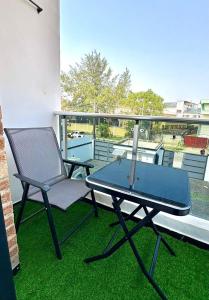 a table and a chair on a balcony at Serene 3BR self-compound in Lekki with Starlink WiFi in Lekki
