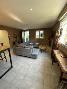 a living room with a couch and a table at La Calypso maison atypique in Sète