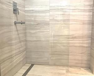 a shower with a glass door in a bathroom at Stylish Apartment in Old Town in Sarajevo