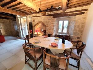 a dining room with a wooden table and chairs at La grange 