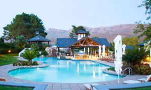 a large swimming pool in front of a house at Luxury Lodge 4F Pearl Valley Golf Estate in Simondium