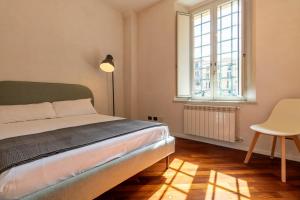 a bedroom with a bed and a table and a window at Apartment Next to St Peter in Rome