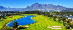 a golf course with a lake and mountains in the background at Luxury Villa 712 Pearl Valley Golf Estate in Paarl