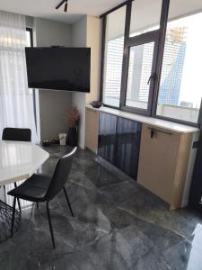 an office with a desk and a table and some windows at Intourist Residence in Batumi +44 photos