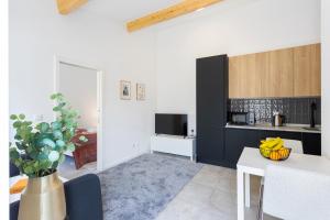 a living room with a table and a kitchen at Bright Flat | Romantic Escape by HostWise in Porto