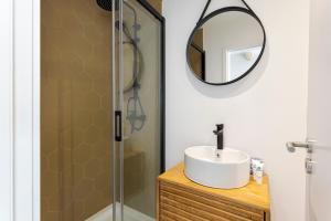 a bathroom with a sink and a mirror at Bright Flat | Romantic Escape by HostWise in Porto