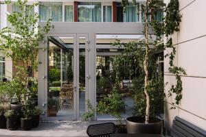 a courtyard with potted plants in front of a building at PURO Wrocław Stare Miasto in Wrocław