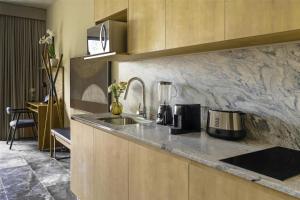 a kitchen with a sink and a counter top at NH Guadalajara Studios in Guadalajara