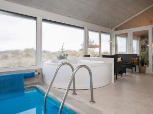a bathroom with a tub and a swimming pool at Charming Eco Cottage with Pool - By Traum Ferienwohnungen in Grønhøj +26 photos