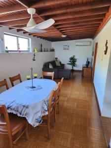 a dining room with a table and chairs at Ocean's Edge in Horta