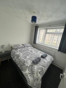 a bed in a bedroom with two pairs of shoes on it at 76 Brambles Chine, 2 bedroom bungalow in beautiful holiday village, 1 night stays and Ferry travel offer available in Isle of Wight