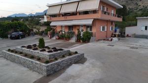 a building in a parking lot in front of a building at Acheron Whisper by ΜΡS in Chóïka +5 photos