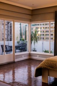 an empty living room with large windows and a table at The Ultimate Luxury Stay at garden city in Cairo