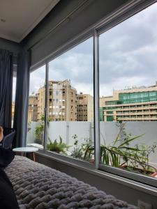 a bedroom with a view of a city through windows at The Ultimate Luxury Stay at garden city in Cairo +4 photos