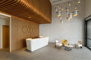 a lobby with a table and chairs and a chandelier at OZO George Town Penang in George Town +34 photos