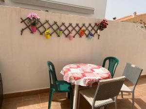 a table and chairs with plants on a wall at Mirador de Turre in Turre