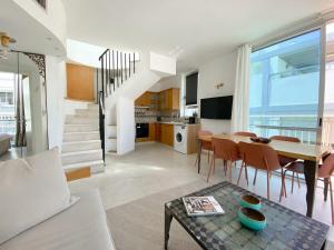 a living room with a table and a dining room at Sea View Duplex On Frishman Beach 2Bdr apt and BBQ in Tel Aviv