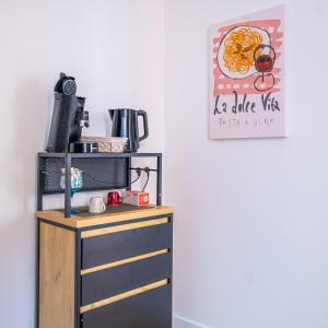 a kitchen with a table with a microwave on top of it at Confort & circuit - Séjour idéal au Mans in Le Mans
