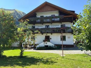 a building with a balcony on top of it at Gästehaus Zugspitzblick in Berwang
