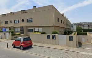 a small red car parked in front of a building at Serene Coastal Retreat with king Beds & Pool in Lavra in Lavra