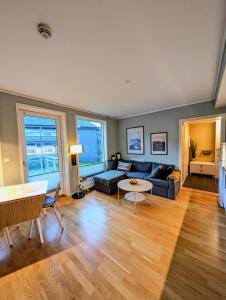 a living room with a couch and a table at Koselig og moderne 2-roms leilighet in Tromsø