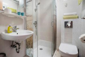 a bathroom with a shower and a sink and a toilet at Ferienbungalows Werner in Ostseebad Koserow +23 photos