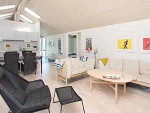 a living room with a couch and chairs and a table at Tranquil Retreat in Nature - By Traum Ferienwohnungen in Ålbæk