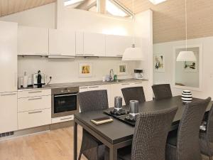 a kitchen with a dining room table and chairs at Tranquil Retreat in Nature - By Traum Ferienwohnungen in Ålbæk +12 photos