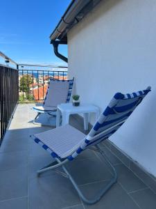 a lounge chair and a table on a balcony at SummerBlue - Синьо лято in Lozenets +9 photos