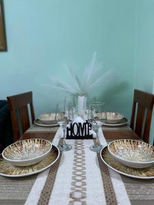 a table with plates and wine glasses on it at Sweet Escape in Shkodër