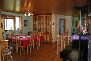 a dining room with a red table and chairs at La Casa Verde in Islallana