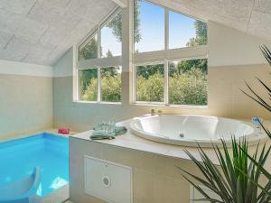 Swimmingpoolen hos eller tæt på 18 person holiday home in Hasselberg + 16 billeder