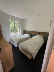 two beds in a room with a window at Montignac Lascaux Home 