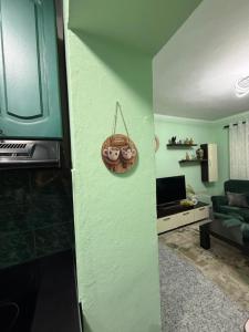 a living room with a green wall at Sweet Escape in Shkodër +49 photos