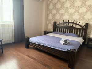 a bedroom with a bed with two stuffed animals on it at Посейдон ЖМ Амангельды ул Тепличная 4 in Kostanay