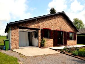 a small brick house with a garage at Pet Escape in Ardennes in Baillamont
