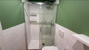 a bathroom with a shower and a toilet at Suite n15 - Design & Relax near the Navigli in Milan